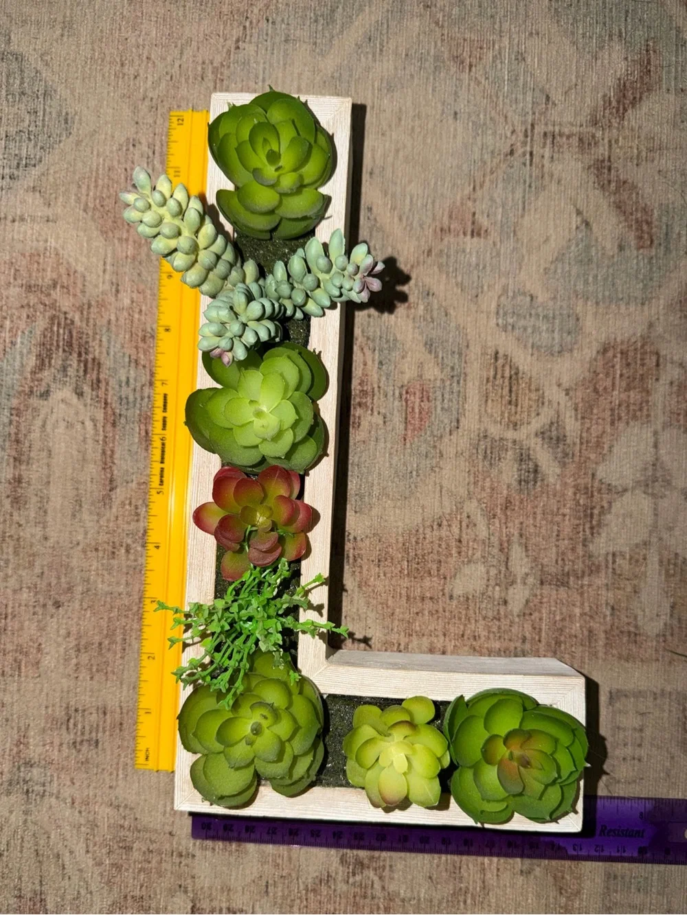 Green L-Shaped Wall Planter with Green Succulent Accents.